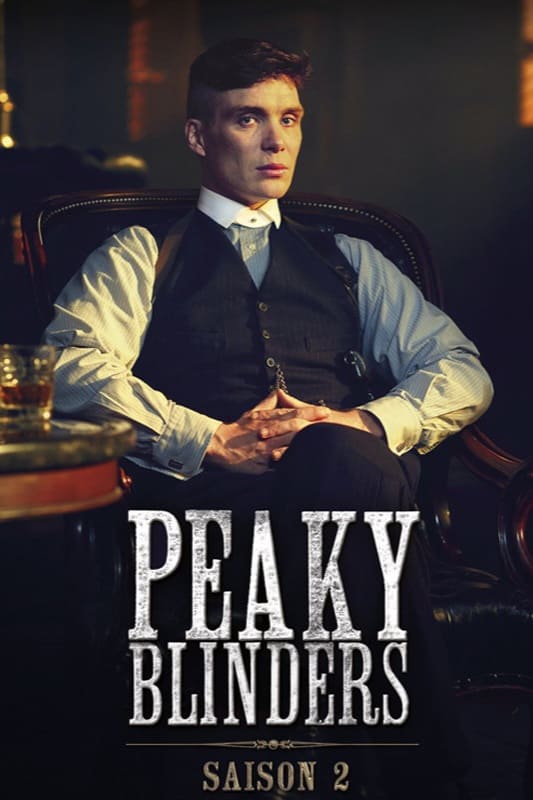 A man in a suit sits in a leather chair with his hands folded. The text Peaky Blinders Saison 2 appears at the bottom, hinting at the show’s dark and dramatic atmosphere. Perfect for fans streaming via IPTV Italy, this scene sets the tone for an intense season.